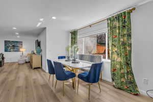 Dining space featuring light wood-style flooring and recessed lighting