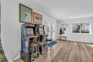 Game room with light wood finished floors, french doors, and recessed lighting