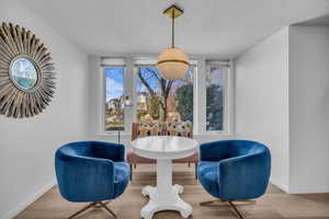 Sitting room featuring a textured ceiling and wood finished floors