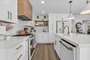 Kitchen featuring white appliances, open shelves, white cabinets, and light stone countertops