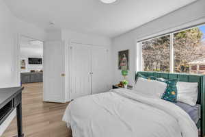 Bedroom with light wood-style flooring and a closet