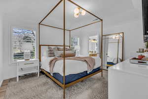 Bedroom with connected bathroom and crown molding