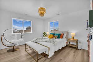 Bedroom featuring light wood-style flooring and baseboards