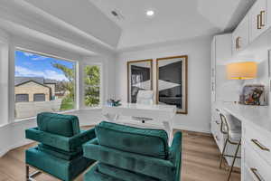 Sitting room featuring a tray ceiling, light wood-type flooring, and recessed lighting