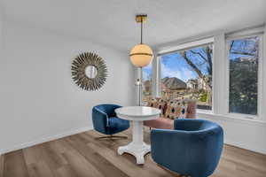 Living area featuring wood finished floors and a textured ceiling