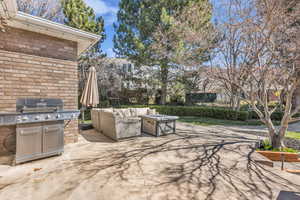 View of patio with an outdoor hangout area and area for grilling