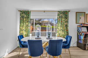Dining space with wood finished floors and baseboards