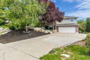 Spacious concrete driveway fronting a two-story residence with a two-car garage