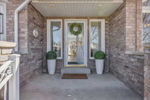 Property entrance featuring brick siding