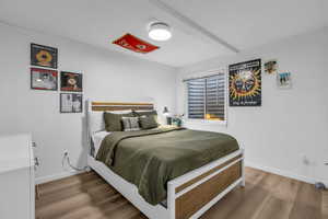Bedroom featuring light wood finished floors and baseboards