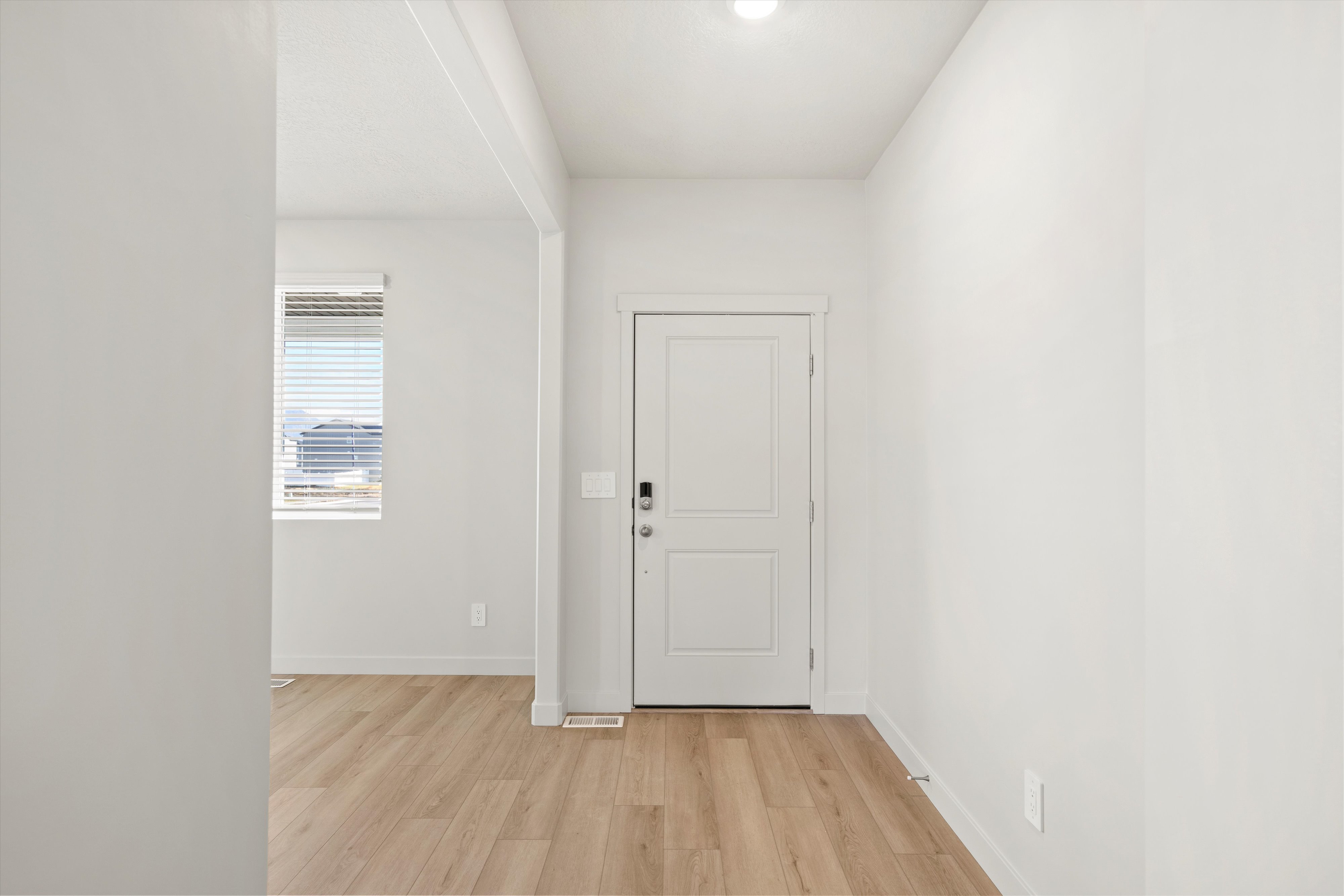 Entryway featuring wood finished floors and baseboards