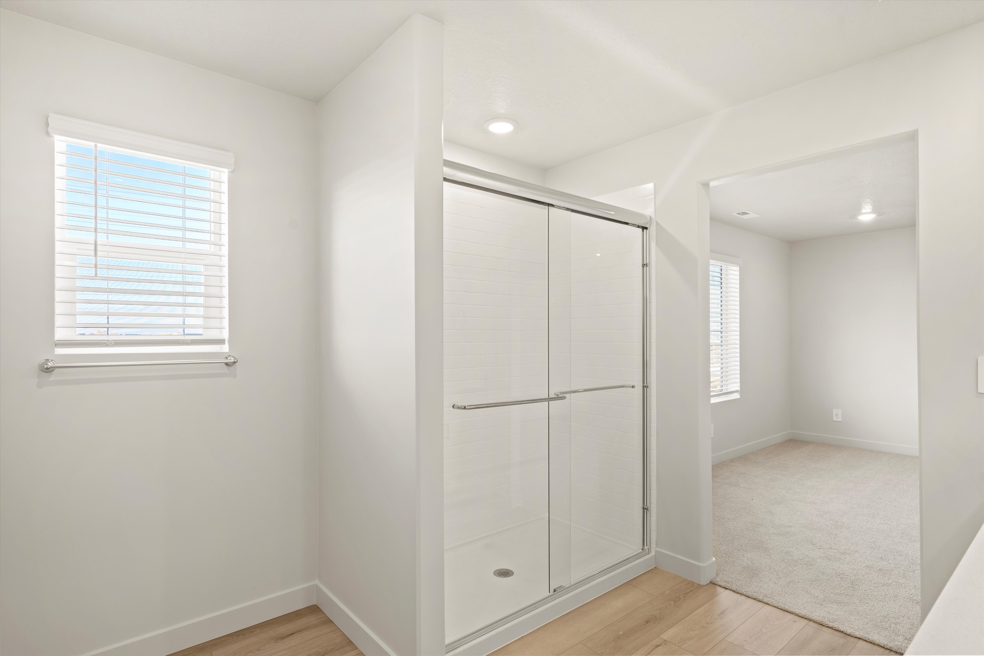 Bathroom with light wood-style floors and a shower stall