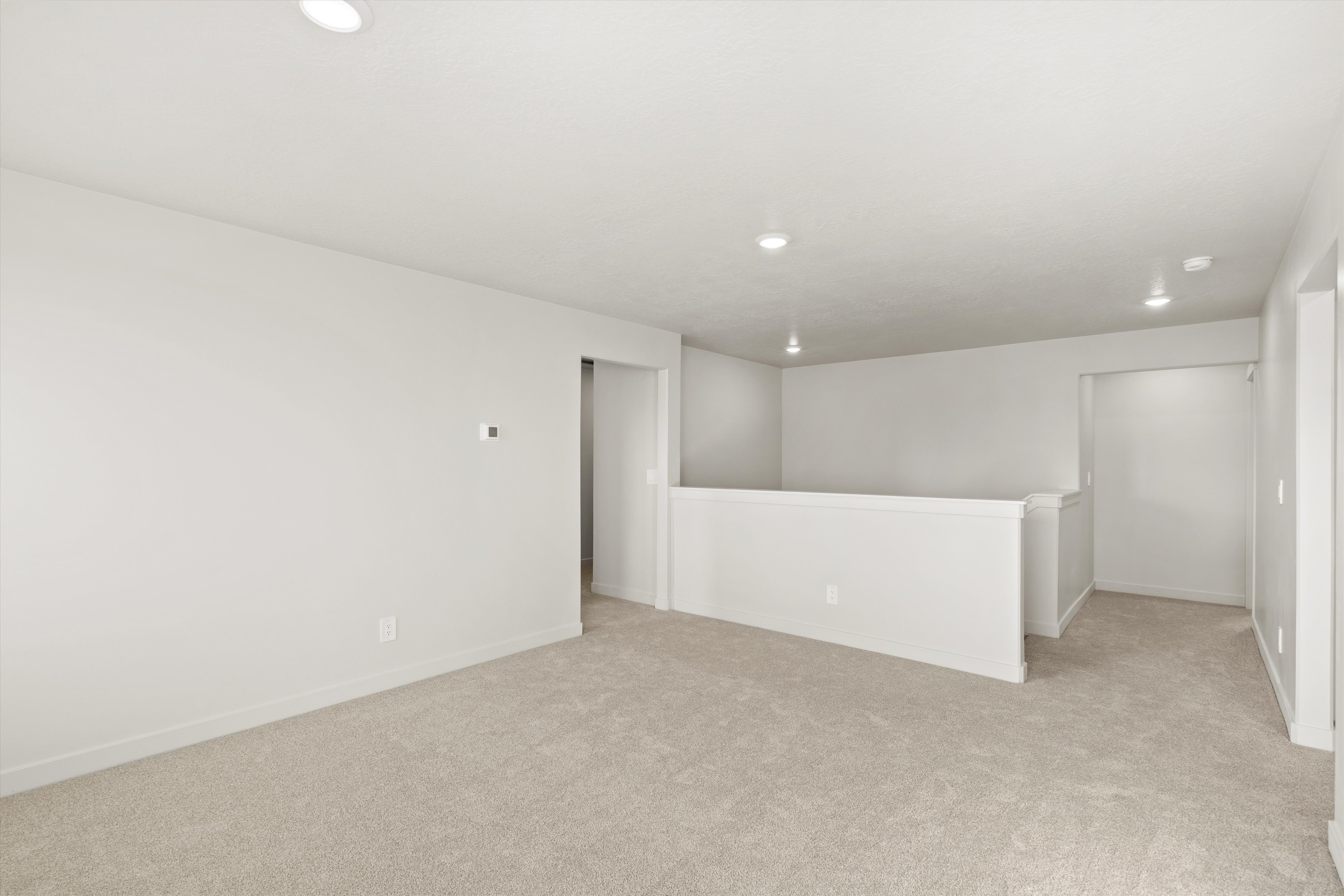 Unfurnished room featuring light carpet and recessed lighting