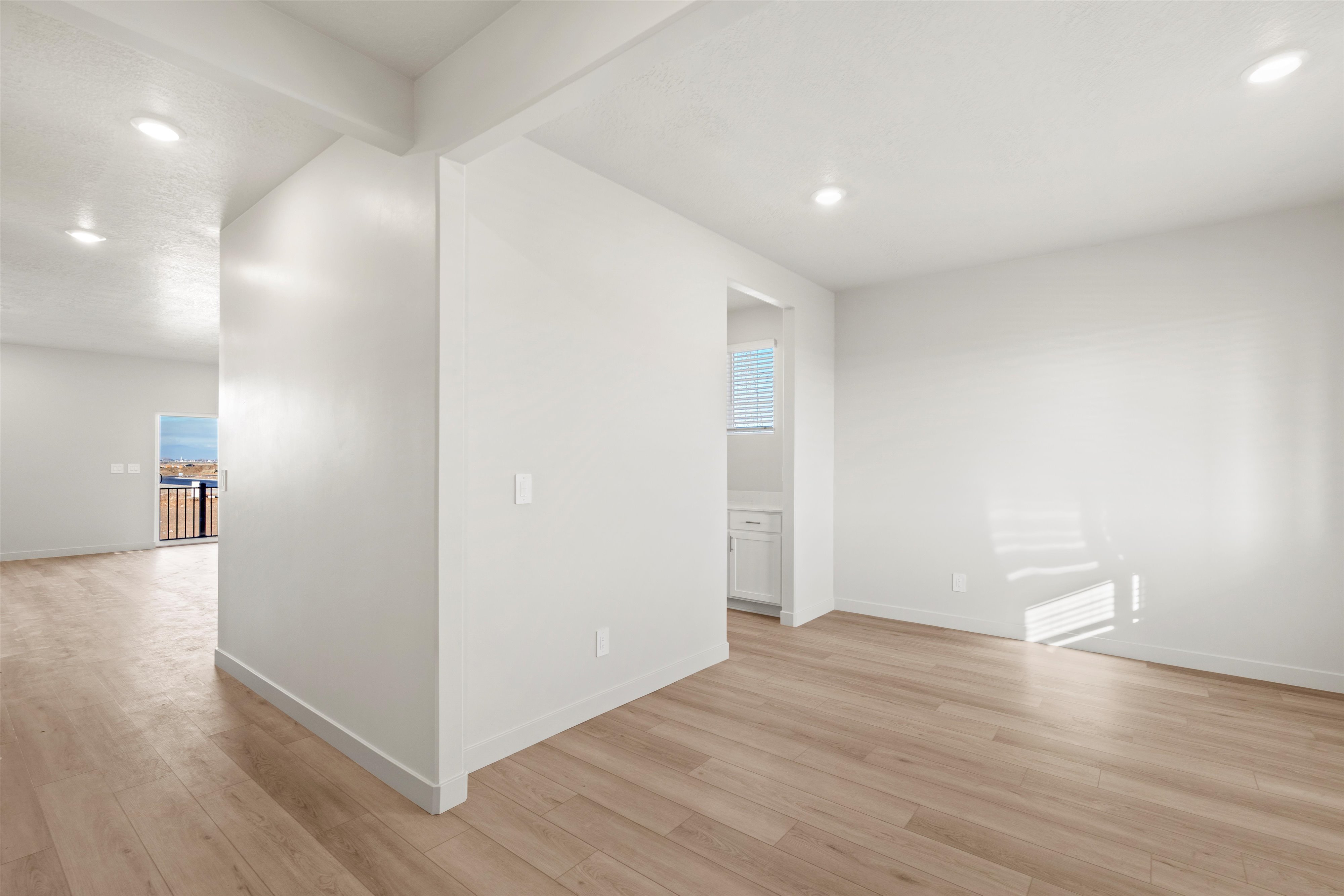 Unfurnished room with beam ceiling, recessed lighting, and light wood-type flooring