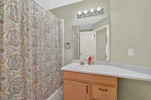 Bathroom featuring vanity, a shower with curtain, and light tile patterned floors