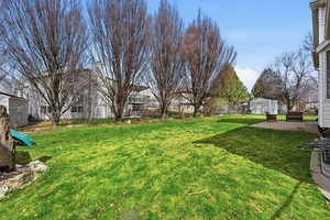 Fenced backyard featuring a patio and a residential view