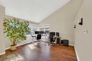 Office with hardwood / wood-style flooring and lofted ceiling