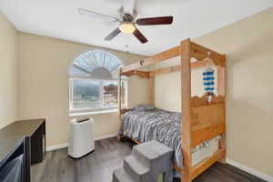 Bedroom featuring dark wood-style floors and a ceiling fan