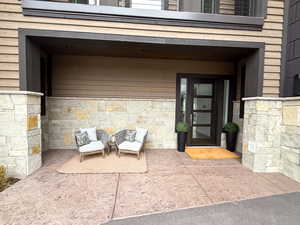 Entrance to property featuring stone siding