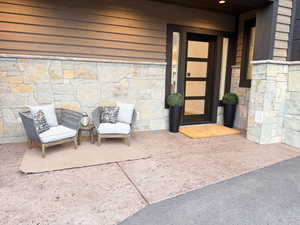 Doorway to property featuring stone siding