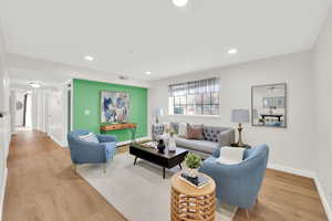 Living area featuring light wood-type flooring and recessed lighting
