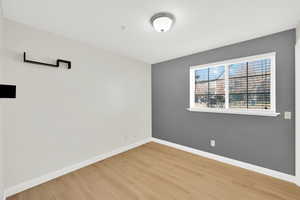 Unfurnished room with baseboards and light wood-style flooring