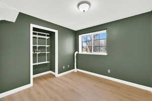 Spare room featuring light wood finished floors and a textured ceiling