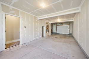 View of garage, entry, storage, water heater, and furnace