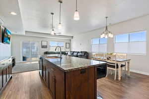 Designer herringbone subway tile backsplash, black stainless steel appliances, soft-close cabinet doors and drawers, pendant lighting,  large pantry