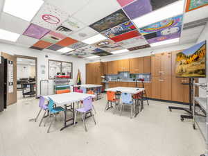 Dining space featuring light flooring and a drop ceiling