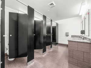Bathroom featuring vanity and tile walls
