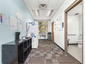 Hallway featuring a drop ceiling