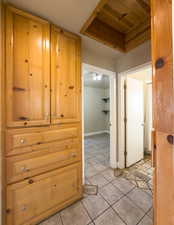 Hallway with light tile patterned floors