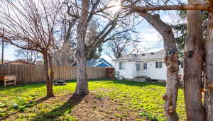 Fenced backyard with an outdoor fire pit