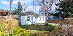 Rear view of house featuring roof with shingles
