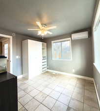 Unfurnished bedroom with a textured ceiling and a ceiling fan