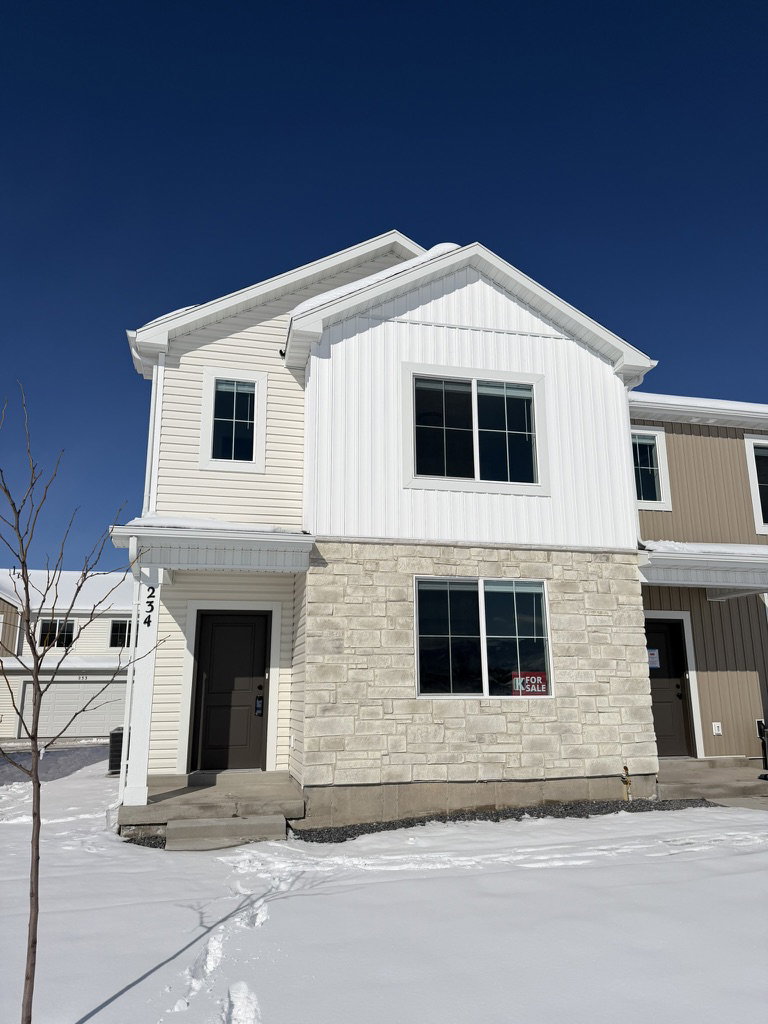 View of front of house with stone siding
