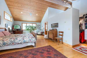 Bedroom featuring a vaulted wood ceiling and light wood finished floors