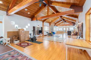 Exercise room featuring a high wood beamed ceiling, a ceiling fan, and recessed lighting