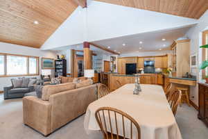 Dining space with recessed lighting, light carpet, and a high wooden ceiling
