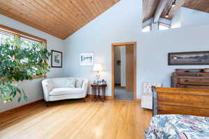 Sitting room featuring a high wood beamed ceiling and light wood-type flooring