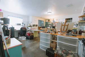 Miscellaneous room featuring concrete floors and a textured ceiling