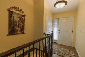 Foyer featuring light tile patterned flooring and baseboards