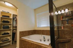 Full bath with a stall shower and a garden tub