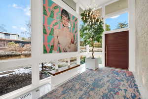 Foyer with a high ceiling and hanging lights