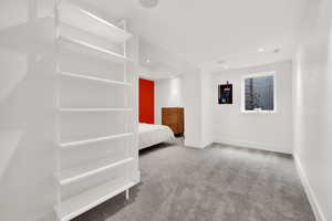 Unfurnished bedroom with light carpet and recessed lighting