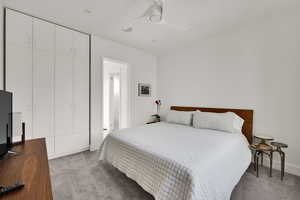 Bedroom featuring light colored carpet and ceiling fan