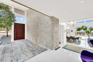 Entrance foyer featuring light tile patterned floors and suspended lighting