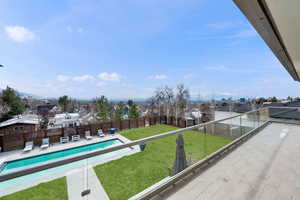 Balcony with a residential view and view of pool area