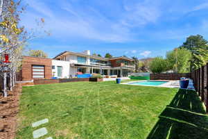 Back of property featuring a patio, a fenced backyard, and a chimney